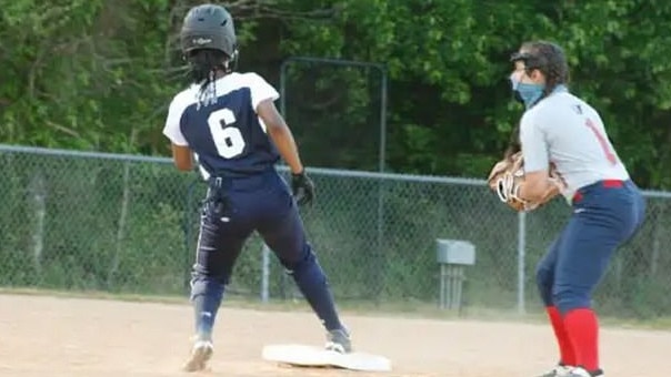 Nicole Pyles (number 6) with her beaded hair that umpires claimed obscured her jersey number when she was playing softball.