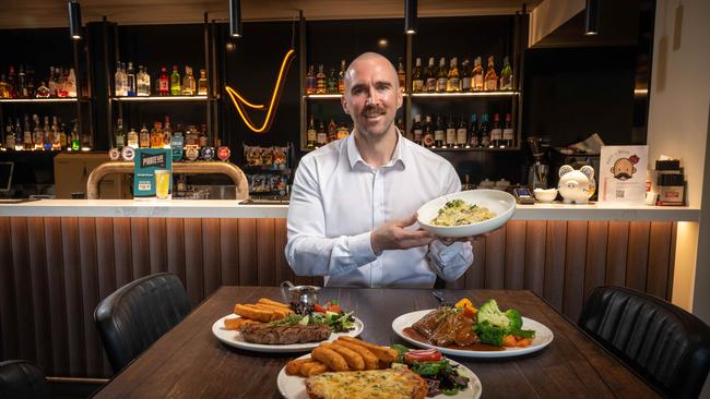 Owner of Jokers On Ryrie Jesse Lewis with some of the pub food on offer. Picture: Brad Fleet