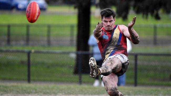 Josh Cowan takes a kick for St Bede’s Mentone Tigers. Photo: Andrew Batsch