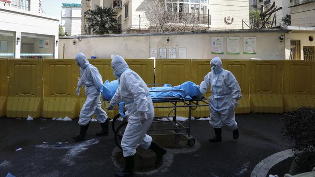 A person who died from COVID-19 is removed from a hospital in Wuhan.