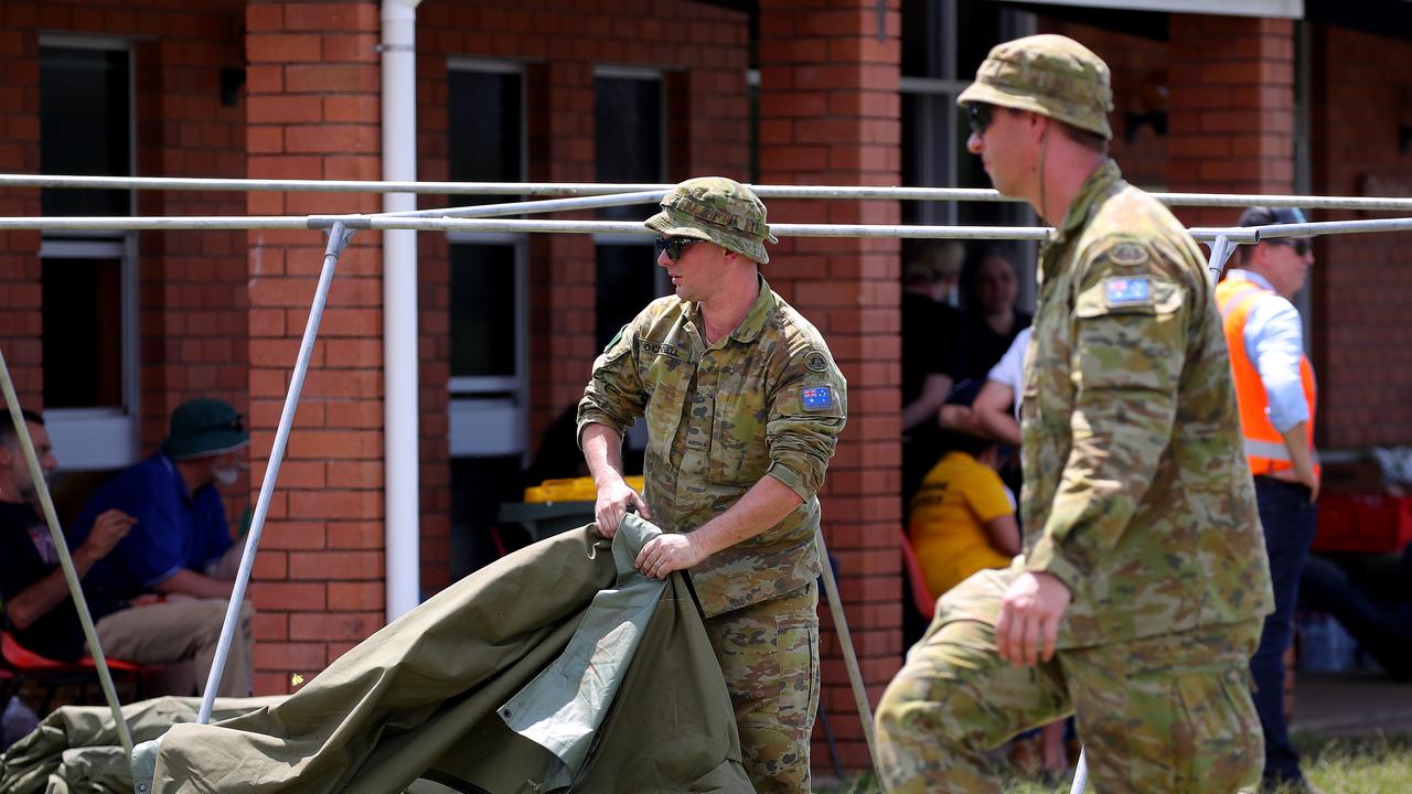 Members of the ADF help to erect tents outside the evacuation centre in Coraki. Picture: Toby Zerna