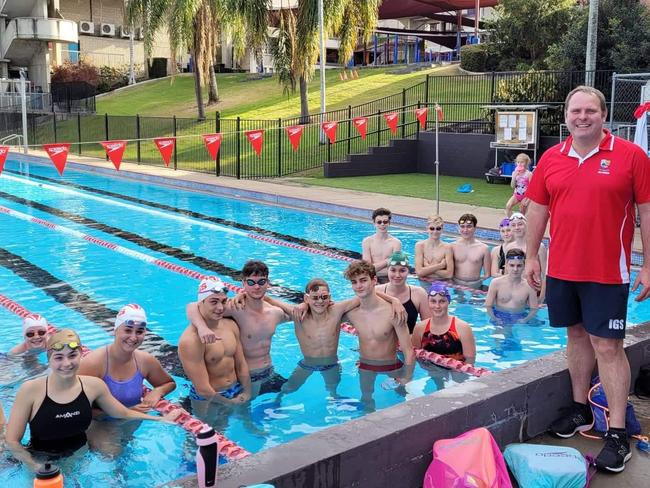 Ipswich Grammar School head coach Tom Harris with some of his squad.