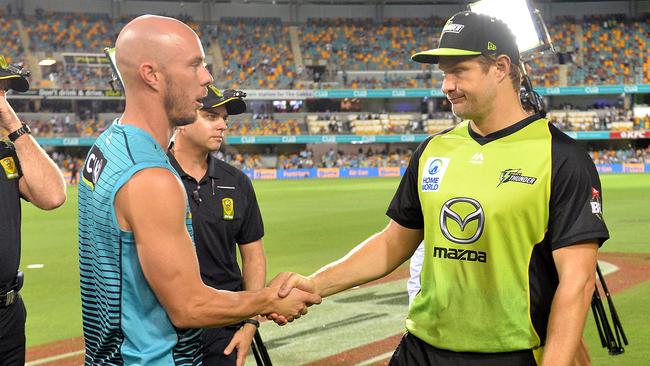 Brisbane Heat captain Chris Lynn (left) and Sydney Thunder captain Shane Watson shake hands after their BBL clash was abandoned on Thursday night. 