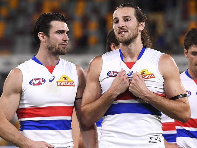 BRISBANE, AUSTRALIA - AUGUST 08: Western Bulldogs players walk off the field after their loss during the round 11 AFL match between the Brisbane Lions and the Western Bulldogs at The Gabba on August 08, 2020 in Brisbane, Australia. (Photo by Albert Perez/Getty Images)