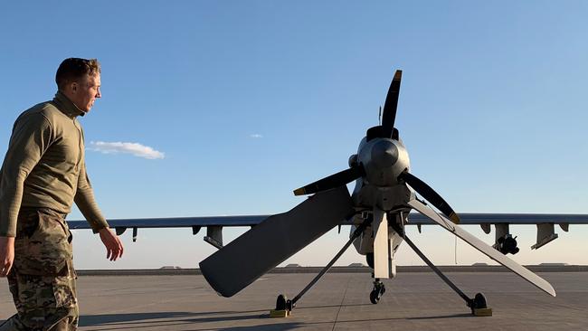 A US soldier walks past an armed drone in Iraq. Australia has no contracts to acquire such drones. Picture: AFP