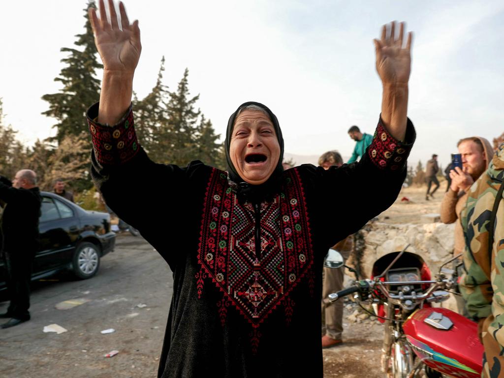 A woman reacts as people gather at Sednaya prison in Damascus looking for loved ones on December 9, 2024. Picture: Omar Haj Kadour/AFP