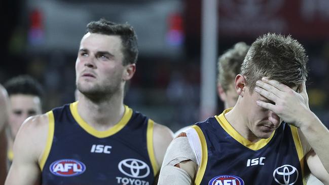 Adelaide’s David McKay puts his head in his hands as he walks off after a loss against Collingwood with Brad Crouch. Picture SARAH REED