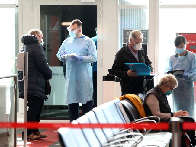 Passengers are checked by health professionals as they arrive at Sydney Airport. Picture: NCA NewsWire / Damian Shaw