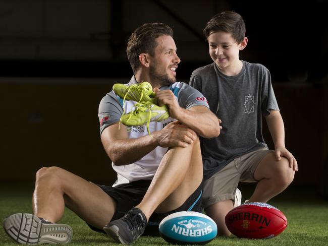 Port Adelaide captain Travis Boak with Ryan Lane-Ellis, 9, at Alberton Oval. Picture: Matt Turner