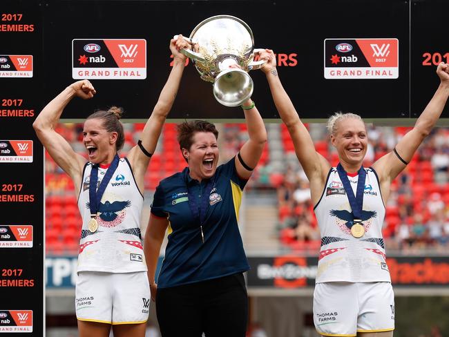 GOLD COAST, AUSTRALIA - MARCH 25: (L-R) Chelsea Randall, Bec Goddard (Coach) and Erin Phillips of the Crows hold the cup aloft after winning the inaugural AFLW Premiership during the 2017 AFLW Grand Final match between the Brisbane Lions and the Adelaide Crows at Metricon Stadium on March 25, 2017 in Gold Coast, Australia. (Photo by Michael Willson/AFL Media/Getty Images)