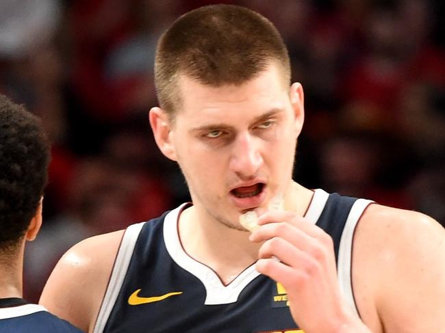 PORTLAND, OREGON - MAY 05: Jamal Murray #27 speaks with teammate Nikola Jokic #15 of the Denver Nuggets during the second half of game four of the Western Conference Semifinals against the Portland Trail Blazers at Moda Center on May 05, 2019 in Portland, Oregon. The Nuggets won 116-112. NOTE TO USER: User expressly acknowledges and agrees that, by downloading and or using this photograph, User is consenting to the terms and conditions of the Getty Images License Agreement.   Steve Dykes/Getty Images/AFP == FOR NEWSPAPERS, INTERNET, TELCOS & TELEVISION USE ONLY ==