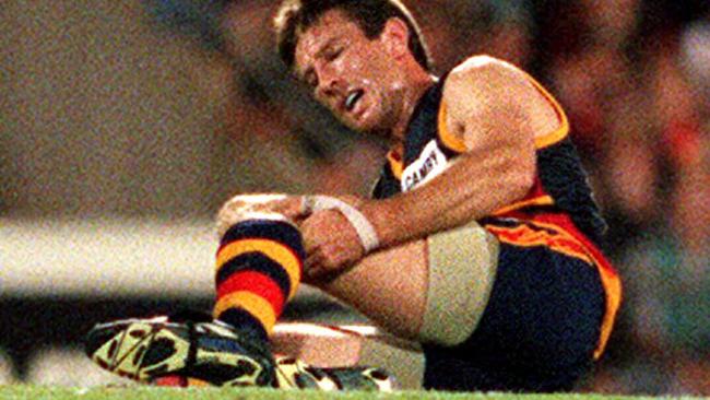 Shaun Rehn clutches his injured knee during the Crows’ pre-season clash with the Power at Football Park in 1999. Picture: Ray Titus