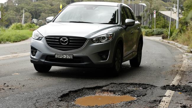 A large pothole on Mccarrs Creek Road at Church Point caused by Tuesday’s deluge. The council has received requests to repair more than 200 potholes so far. Picture: Tim Hunter.