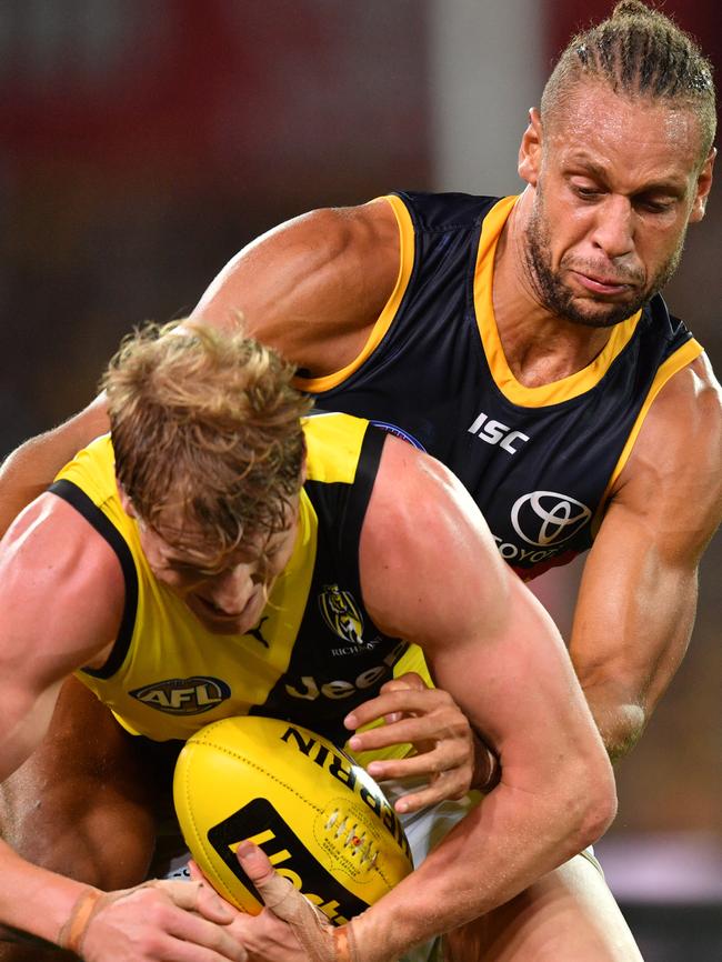 Cam Ellis-Yolmen of the Crows tackles Josh Caddy of the Tigers at Adelaide Oval on Thursday night. Picture: AAP Image/David Mariuz