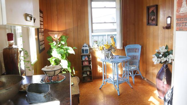 The brown, panelled walls and cork flooring in the dining room.