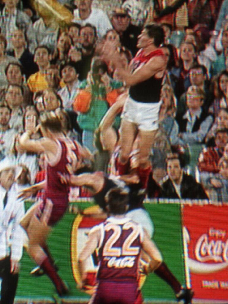 Shaun Smith gets a ride from teammate Garry Lyon.