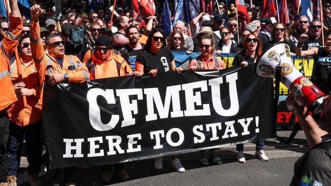 Protesters hold banners and chant slogans as they march in support of the Construction, Forestry and Maritime Employees Union (CFMEU) in central Sydney on September 18, 2024. Thousands of trade workers joined marches in Melbourne and Sydney to protest against the federal government's decision to force the CFMEU's construction arm into administration. (Photo by DAVID GRAY / AFP)