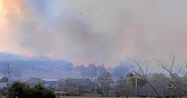 Bec Pattie captured a water bomber trying to douse the flames. . Picture: Bec Patti