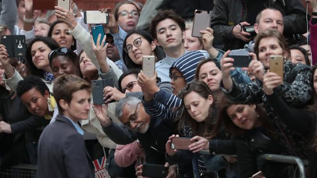 Members of the public crane to have a look at the royal newborn. Picture: AFP