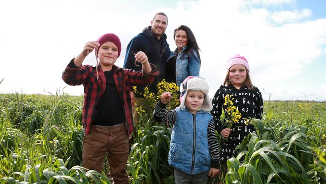 Worm city: Grant and Naomi Sims with children River, Hunter and Shiloh in the paddock they trialed cattle in over summer. Picture: Andy Rogers