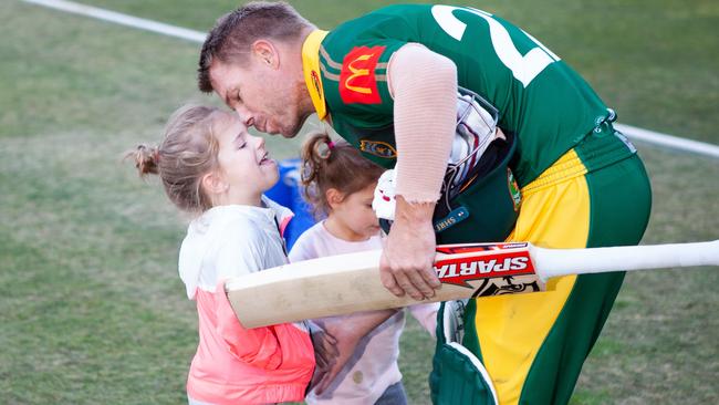 David Warner gives his daughter a kiss as he leaves the field after securing a last ball victory in his return to grade cricket at Coogee Oval. Picture: Luke Drew