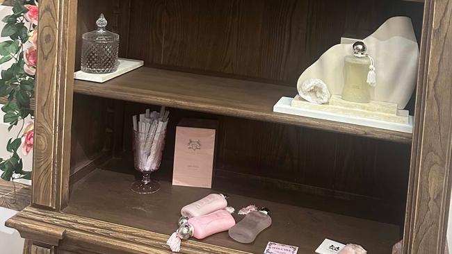 Stripped shelves at Parfumerie Enchante after a robbery that took nearly $30,000 in stock.