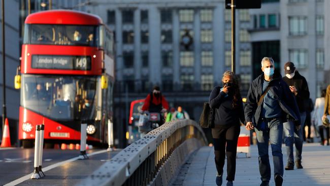 People cross London Bridge as they make their way home in the evening sunshine, in London on September 25. Ten million Londoners have been put on notice.