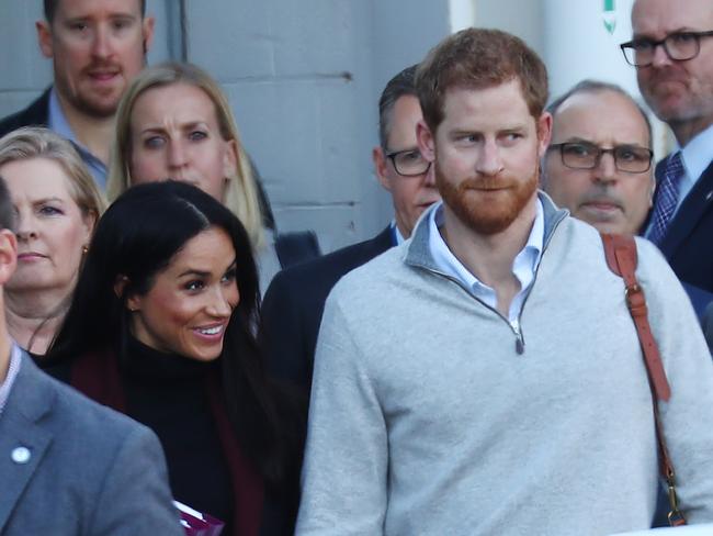 The loved-up pair appeared to be hiding a secret when they arrived at Sydney Airport. Picture: Hollie Adams/The Australian