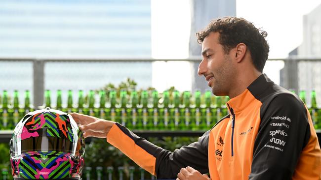 Daniel Ricciardo checks out the one-off helmet design he will sport at the Aussie GP.