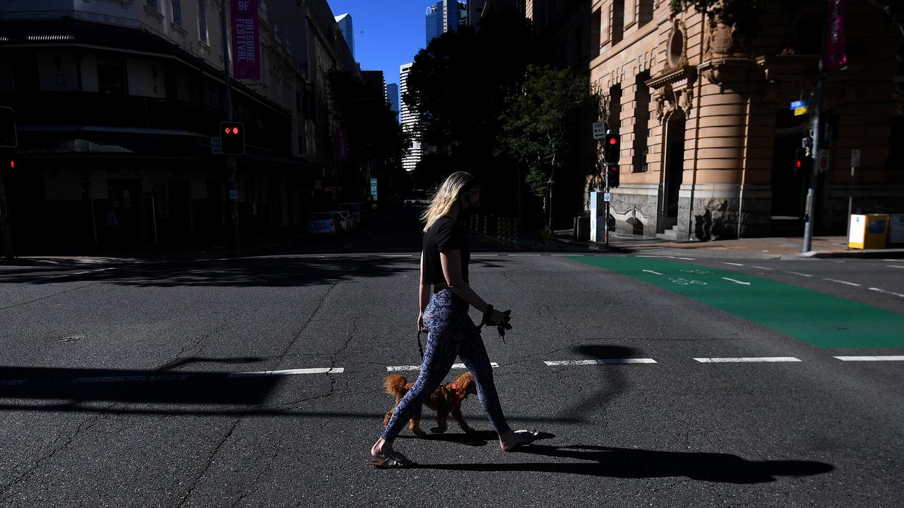 A woman crosses an empty Elizabeth street in central Brisbane during the lockdown. Photo: Dan Peled