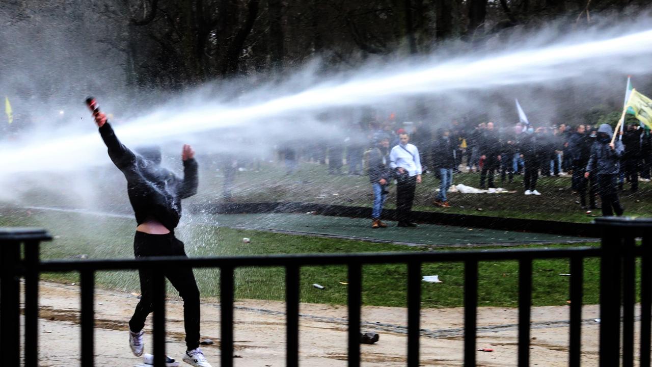 A demonstrator is sprayed with water cannon while clashing with police. Picture: Valeria Mongelli/Bloomberg via Getty Images