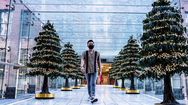 A shopper walks past Christmas trees set up at Westfield Pitt Street in the CBD of Sydney, NSW. Picture: NCA NewsWire/Flavio Brancaleone