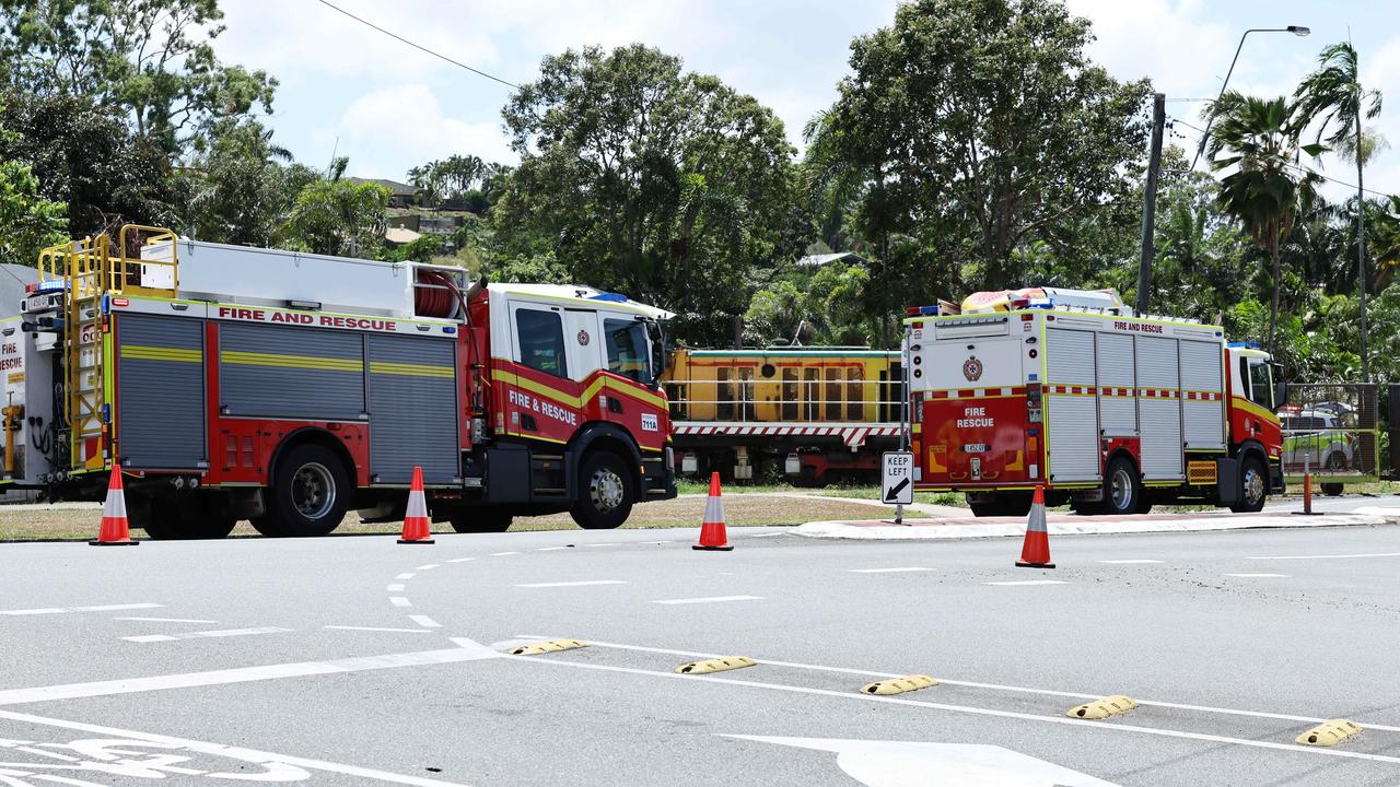 Emergency services personnel respond to a collision between a small car and a cane train at a level crossing on Beatrice Street, Mooroobool. Picture: Brendan Radke