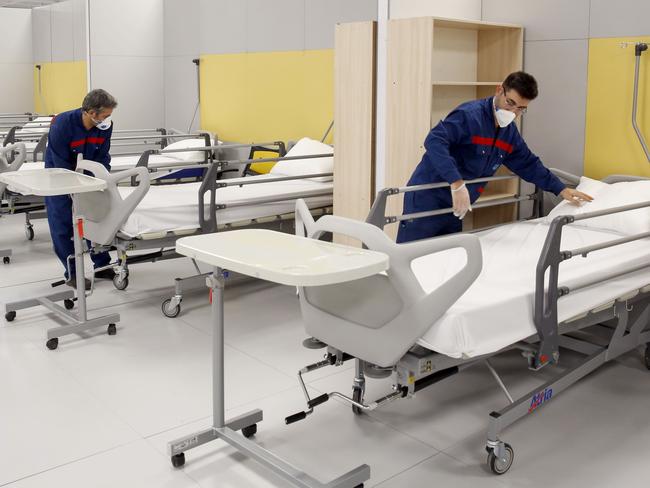 Iranian workers set up a makeshift hospital inside a mall northwest of Tehran, Iran. Picture: AFP