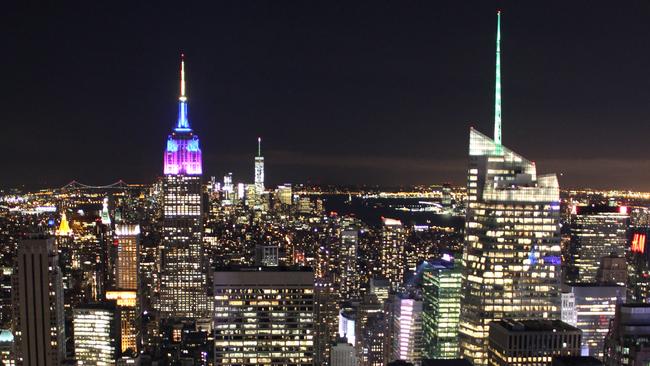 ESCAPE: NEW YORK .. Simon Tsang story .. View of Empire State Building and One World Trade Center at night from Top of the Rock. Picture: Simon Tsang