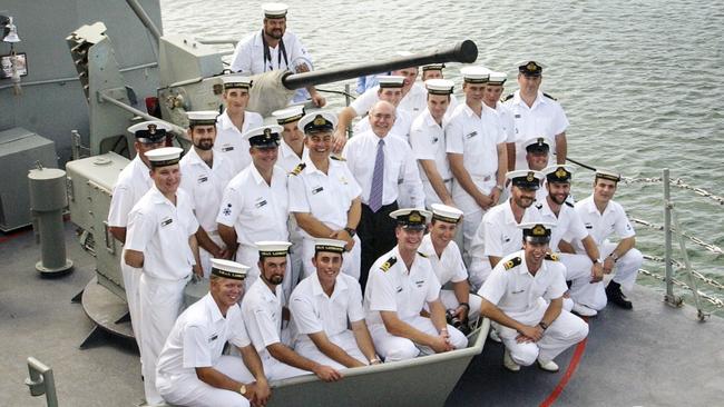 Prime Minister John Howard is flanked by crew members of HMAS Launceston, a patrol vessel tasked with border security operations, in Darwin. Picture: Michael Jones/Commonwealth of Australia