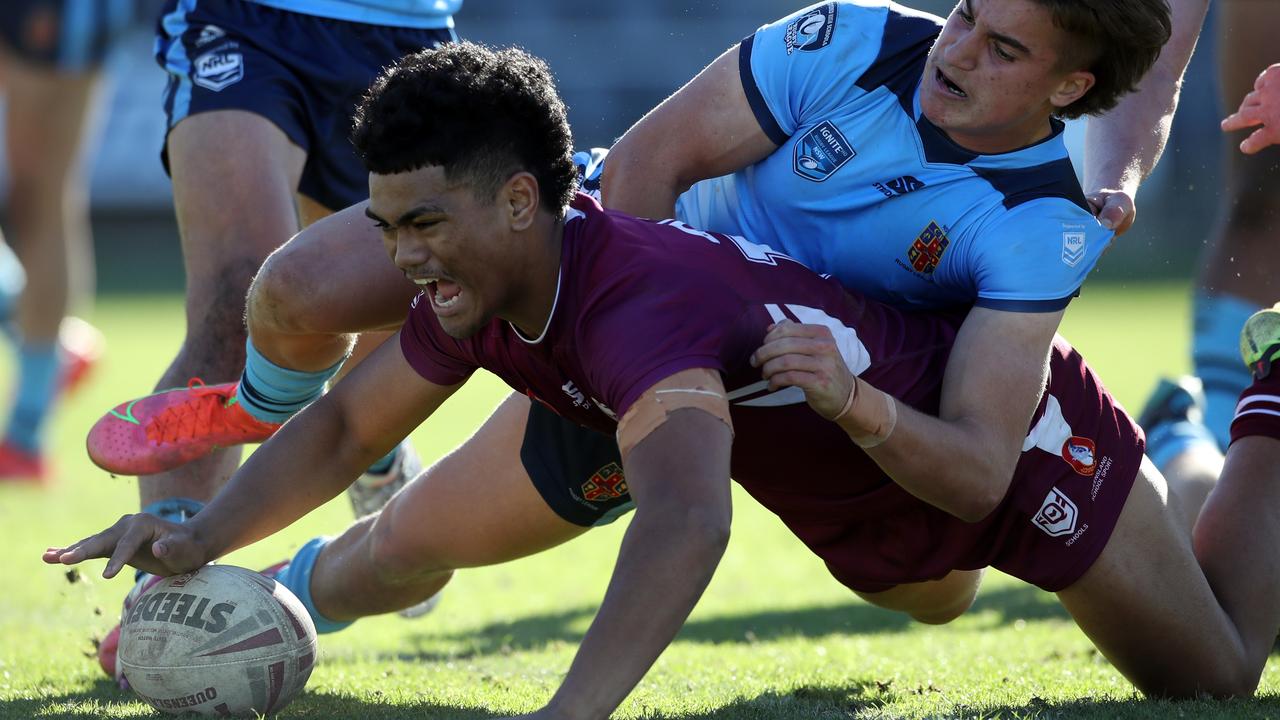 QLD's Karl Oloapu scores a try whilst NSW's Chevy Stewart attempts to tackle during the under 18 ASSRL schoolboy rugby league championship grand final between QLD v NSW CHS from Moreton Daily Stadium, Redcliffe. Picture: Zak Simmonds
