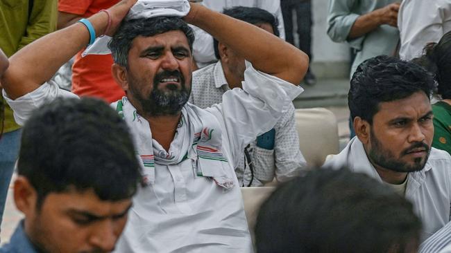 A supporter of the Congress Party reacts as he watches live election results on a television. Picture: AFP