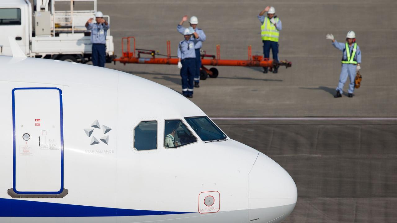 In Japan, it is tradition for ground crew to wave off an aircraft. Picture: Darren Howie / Vortex Aviation Photography