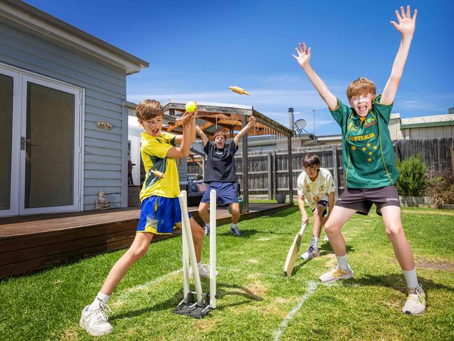 MELBOURNE, DECEMBER 22, 2023: Tom Evanson (black top), 16, Lucas Evanson white top), 14, Josh Evanson (yellow top), 11, and Callum Wickson (green top), 14, get their backyard cricket on in Spotswood. Picture: Mark Stewart