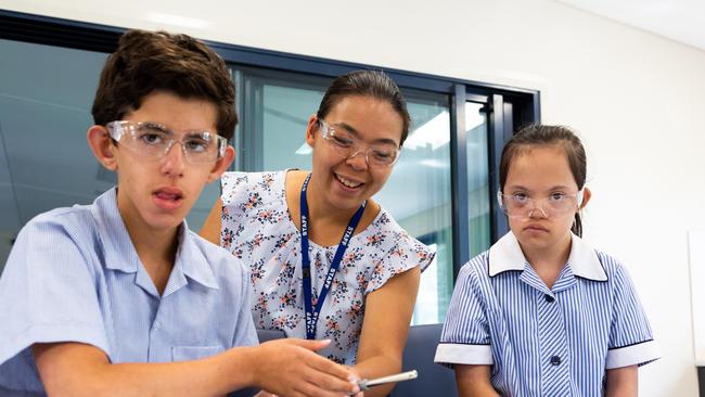 Teacher Belinda Lu with Giuseppe, 12, and Shari-Anne, 12.