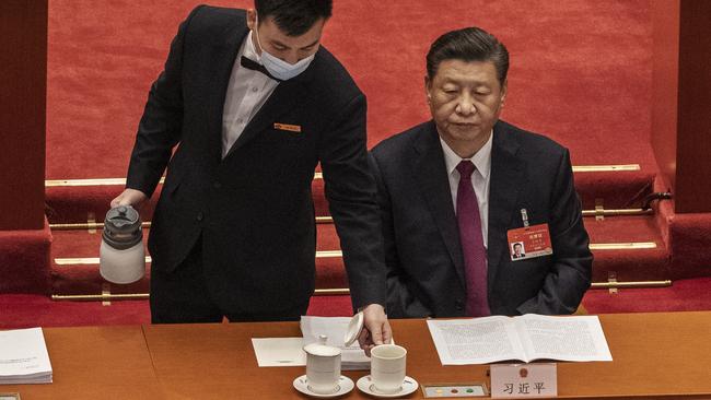 A server pours tea for President Xi Jinping at the opening session of the National People's Congress at the Great Hall of the People in Beijing. Picture: Getty Images