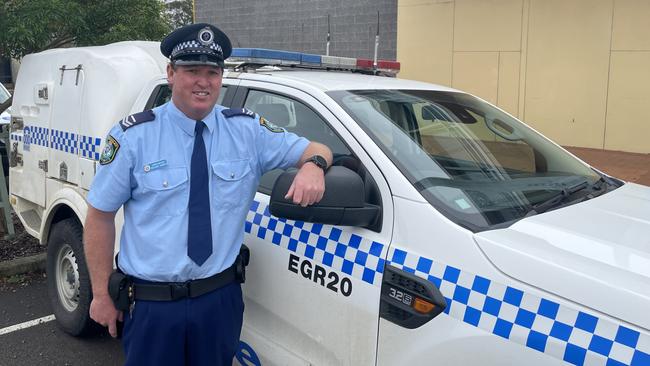 Senior Constable Richie Hansen with his trusty country police vehicle, callsign East Gresford 20, used to save three people from a car after it was washed off a causeway near Dungog Picture: Dan Proudman