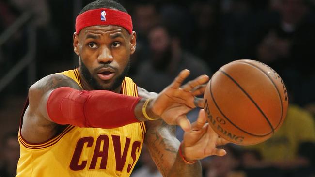 Cleveland Cavaliers forward LeBron James (23) passes around New York Knicks forward Carmelo Anthony (7) in the first half of an NBA basketball game in New York, Thursday, Dec. 4, 2014. (AP Photo/Kathy Willens)