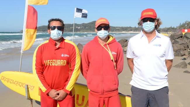 Lifeguards Finley Stubbs, Finn Crisp and supervisor Steve Mills have been placing the flags between the rock groynes at Byron Bay’s Main Beach. Picture: Liana Boss