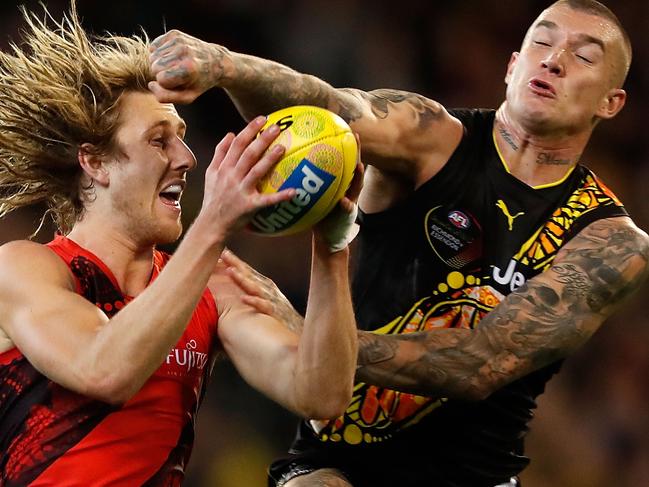 MELBOURNE, AUSTRALIA - MAY 27: Dyson Heppell of the Bombers marks the ball ahead of Dustin Martin of the Tigers during the 2017 AFL round 10 Dreamtime at the G match between the Richmond Tigers and the Essendon Bombers at the Melbourne Cricket Ground on May 27, 2017 in Melbourne, Australia. (Photo by Adam Trafford/AFL Media/Getty Images)