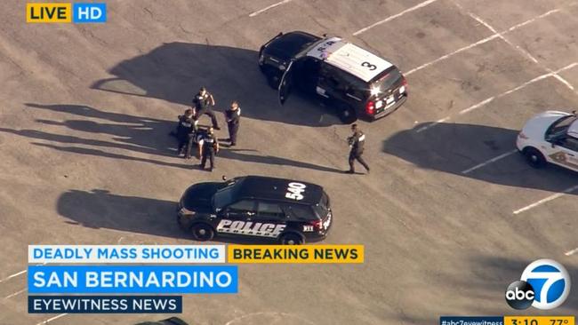 Shootout ... police officers surround a suspect in a San Bernardino parking lot. Picture: KABC