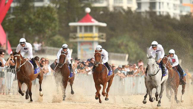 Jockeys charges down the sand at Surfers Paradise. Picture: Chris Hyde/Getty Images