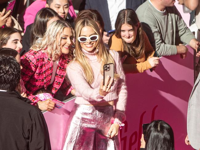 Margot Robbie poses for a selfie with a fan. Picture: Julian Andrews