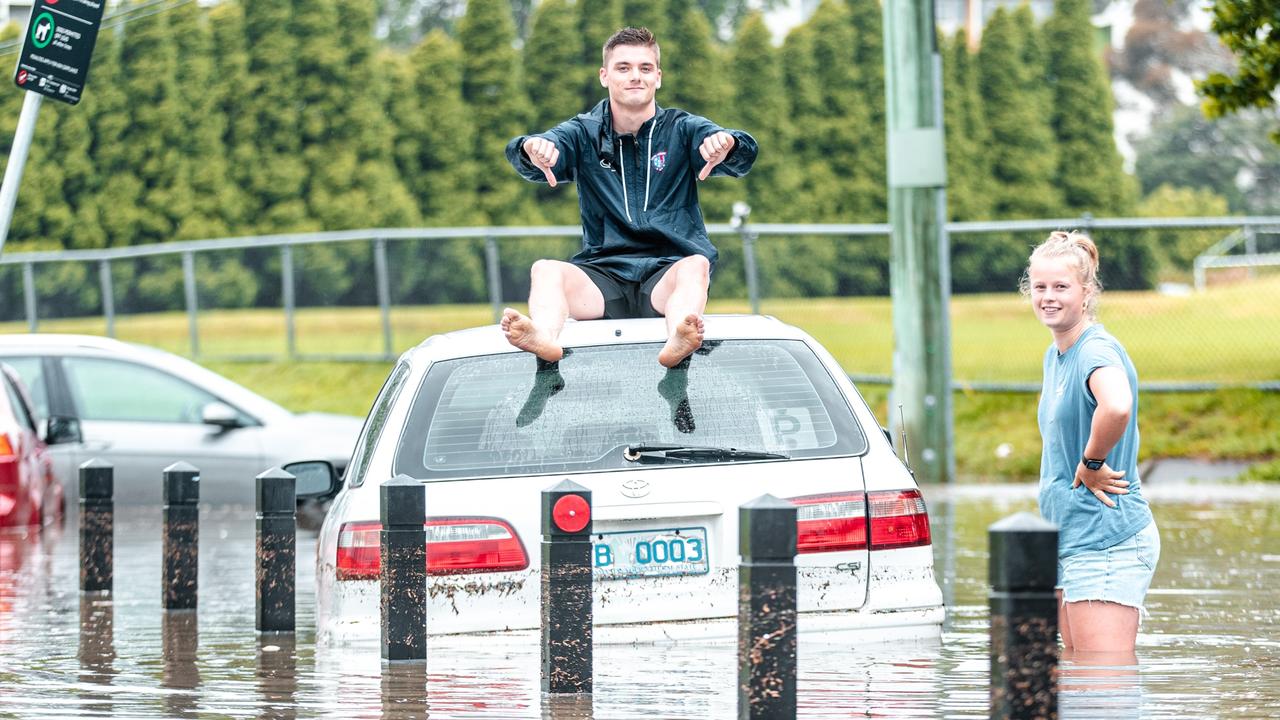 South Hobart soccer players Sam Berezansky, 18, and Issi Declerck were caught up in the sudden deluge and flooding in New Town. Picture: PULSE HOBART/JOSH AGNEW